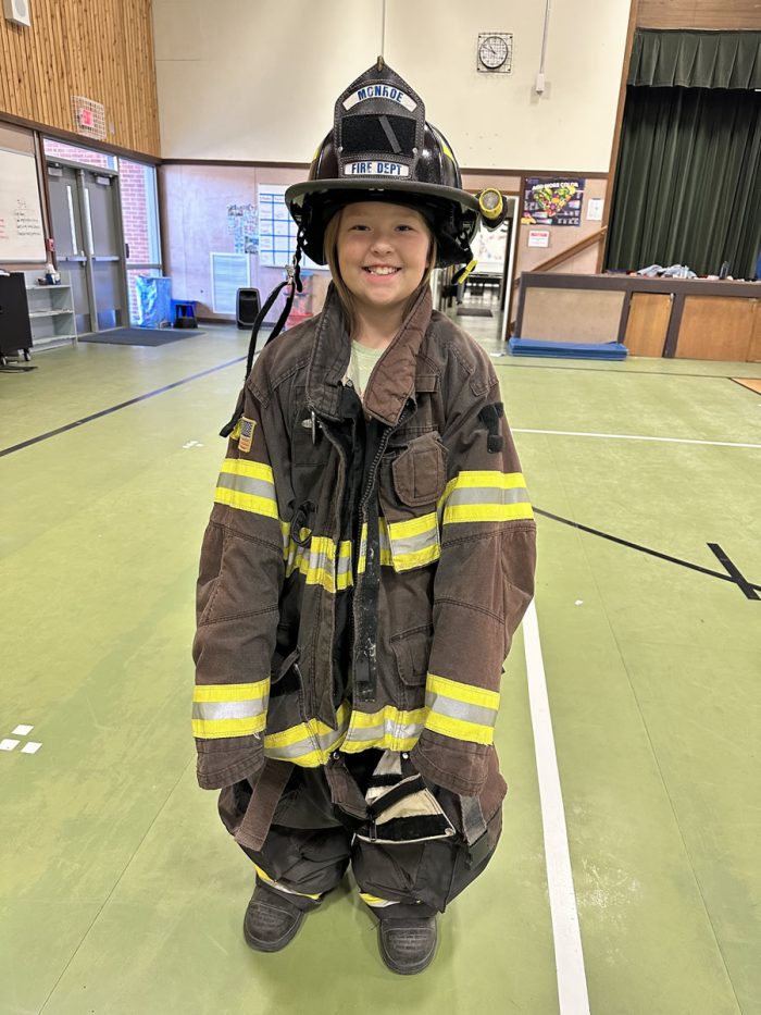 kids trying on firefighter gear
