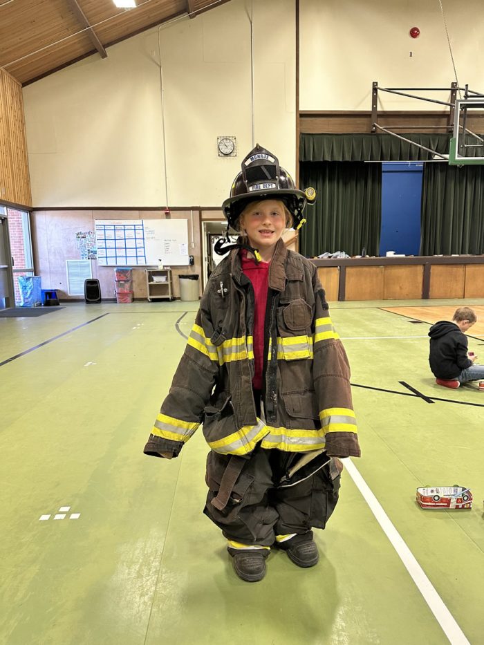 kids trying on firefighter gear