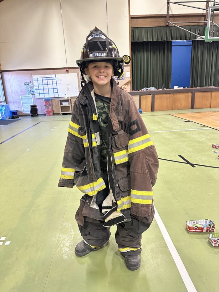 kids trying on firefighter gear