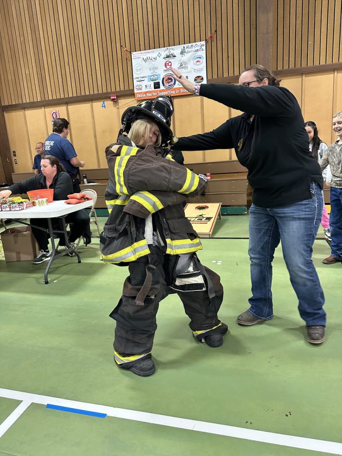 kids trying on firefighter gear